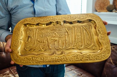 Faez al Sharaa, 28, shows a Syrian plate inscribed with the Shahada he took before fleeing to Jordan at his apartment in Richardson, Texas on Nov. 20, 2015.