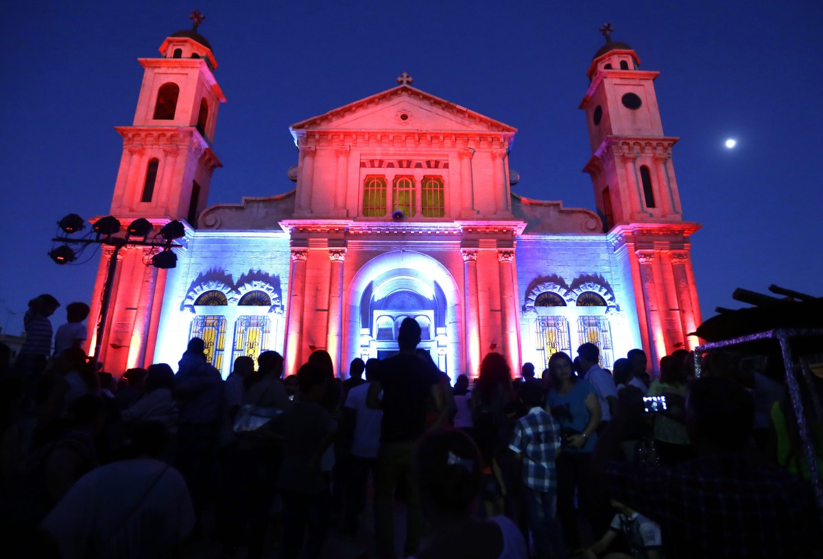 Syrian Christians celebrate the feast of the Holy Cross outside a church in Damascus late on Sept. 13, 2016.