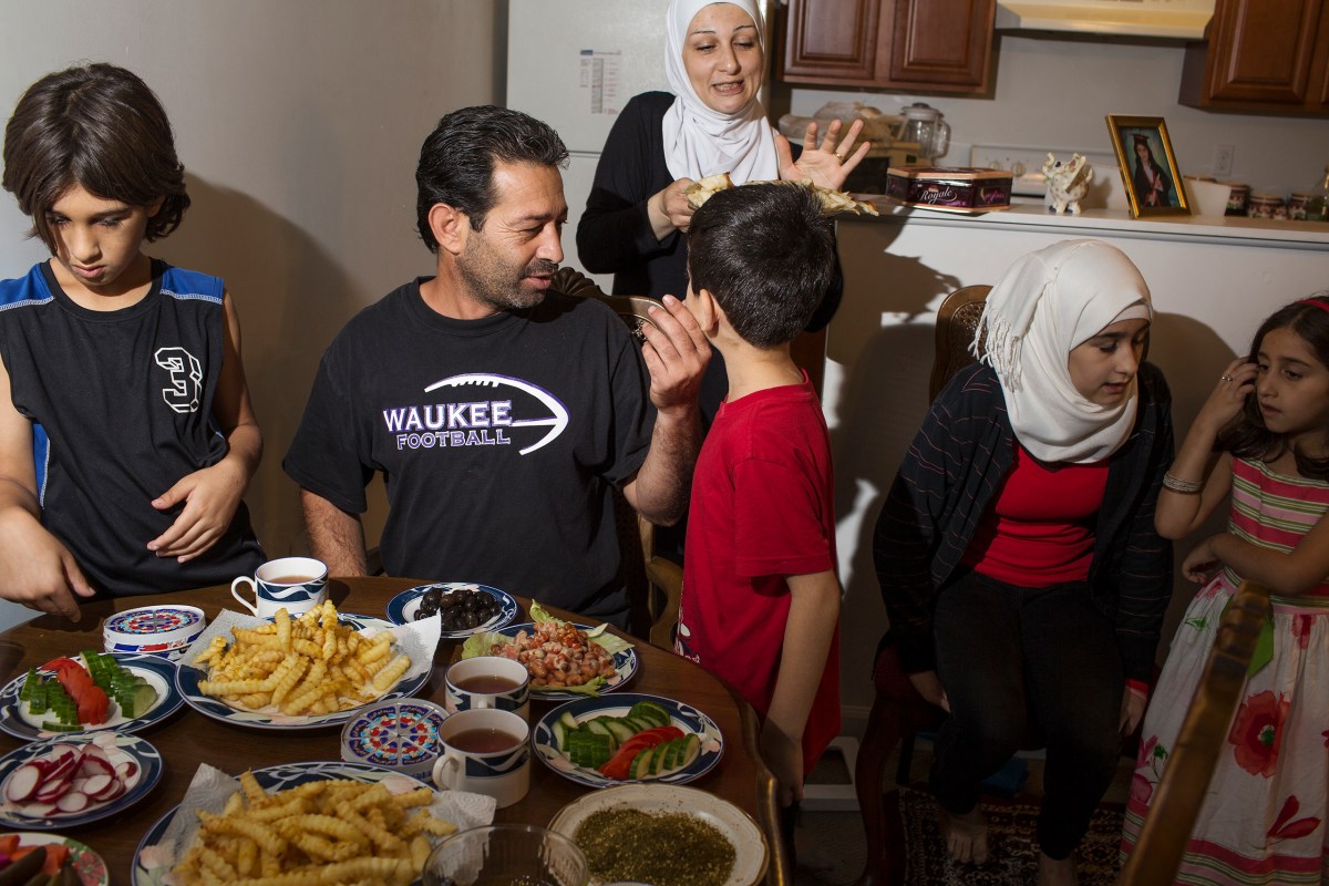 The family gathers for a Sunday meal at their apartment in Des Moines.