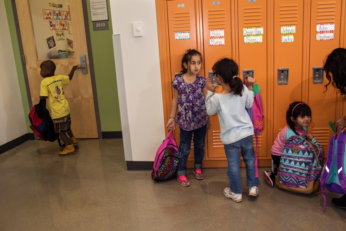 Hala in front of her locker. The elementary school is filled with kids who came to Iowa from some of the world's most violent places.
