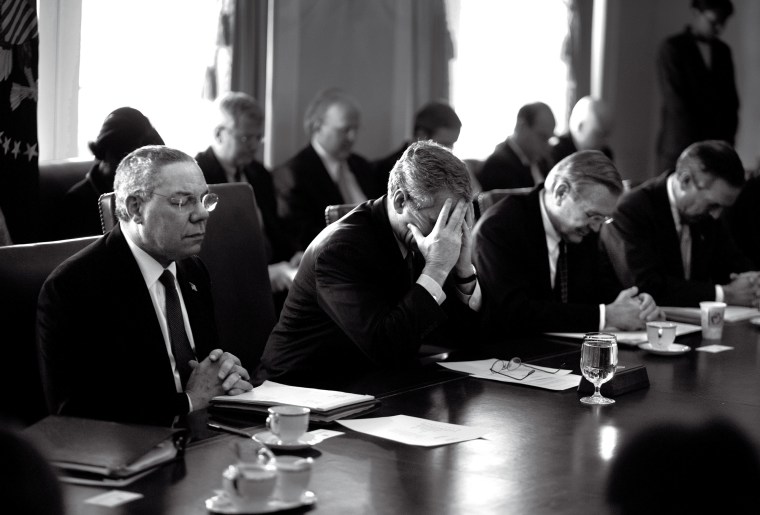 President Bush holds a meeting with his cabinet to discuss his upcoming State of the Union address. Secretary of State Colin Powell and Secretary of Defense Donald Rumsfeld talk before the meeting. President Bush talks with Director of the Environmental Protection Agency Christie Todd Whitman after the meeting. President Bush works on a final draft of his State of the Union address in the Oval Office.EXCLUSIVE