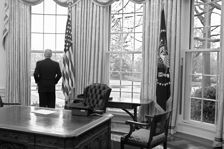 President Clinton takes one final look before exiting the Oval Office for the last time. the only things on his desk are the phone and a note to incoming President Bush, January 20, 2001.