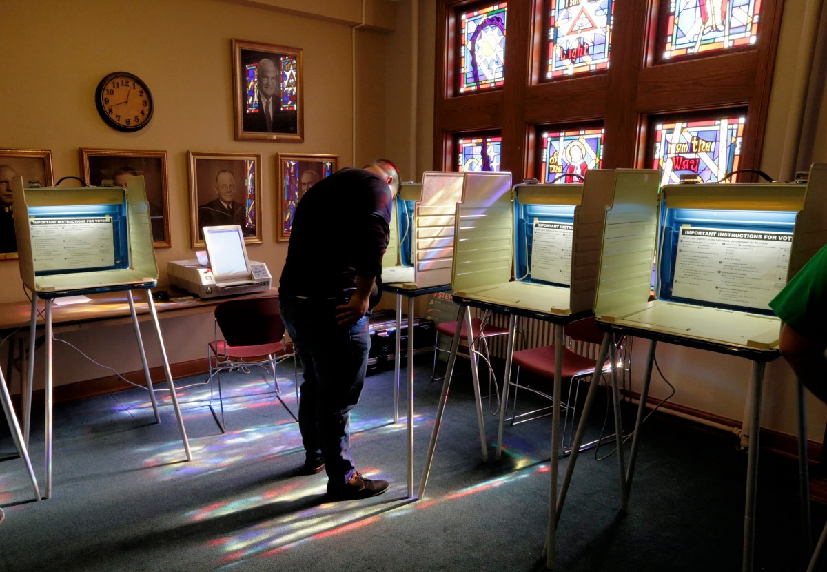 A voter works on his ballot at a polling station on election day, on Nov. 8, 2016, in Omaha, Neb.
