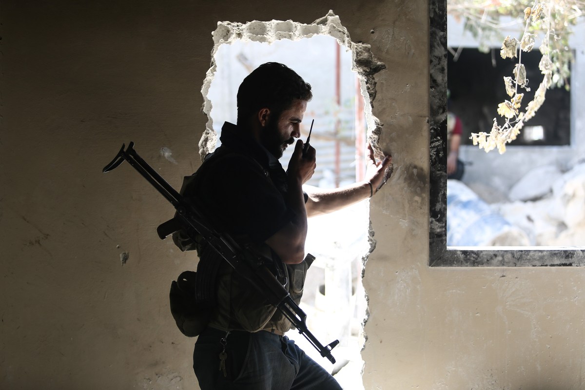 An opposition fighter communicates via radio in Douma on Sept. 5. Mohammed BadraâEPA