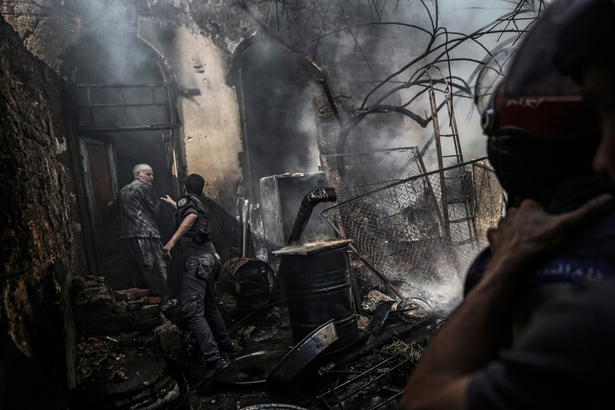 Firefighters at a man's home after an airstrike in Douma on Sept. 11. Mohammed BadraÃ¢ÂÂEPA