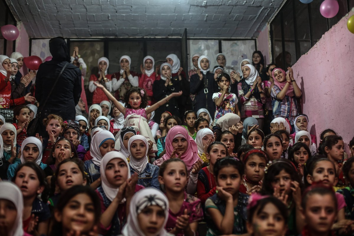 Children listen to songs at an underground amusement park in Erbeen, Eastern Ghouta, on Sept. 16. Mohammed BadraÃ¢ÂÂEPA