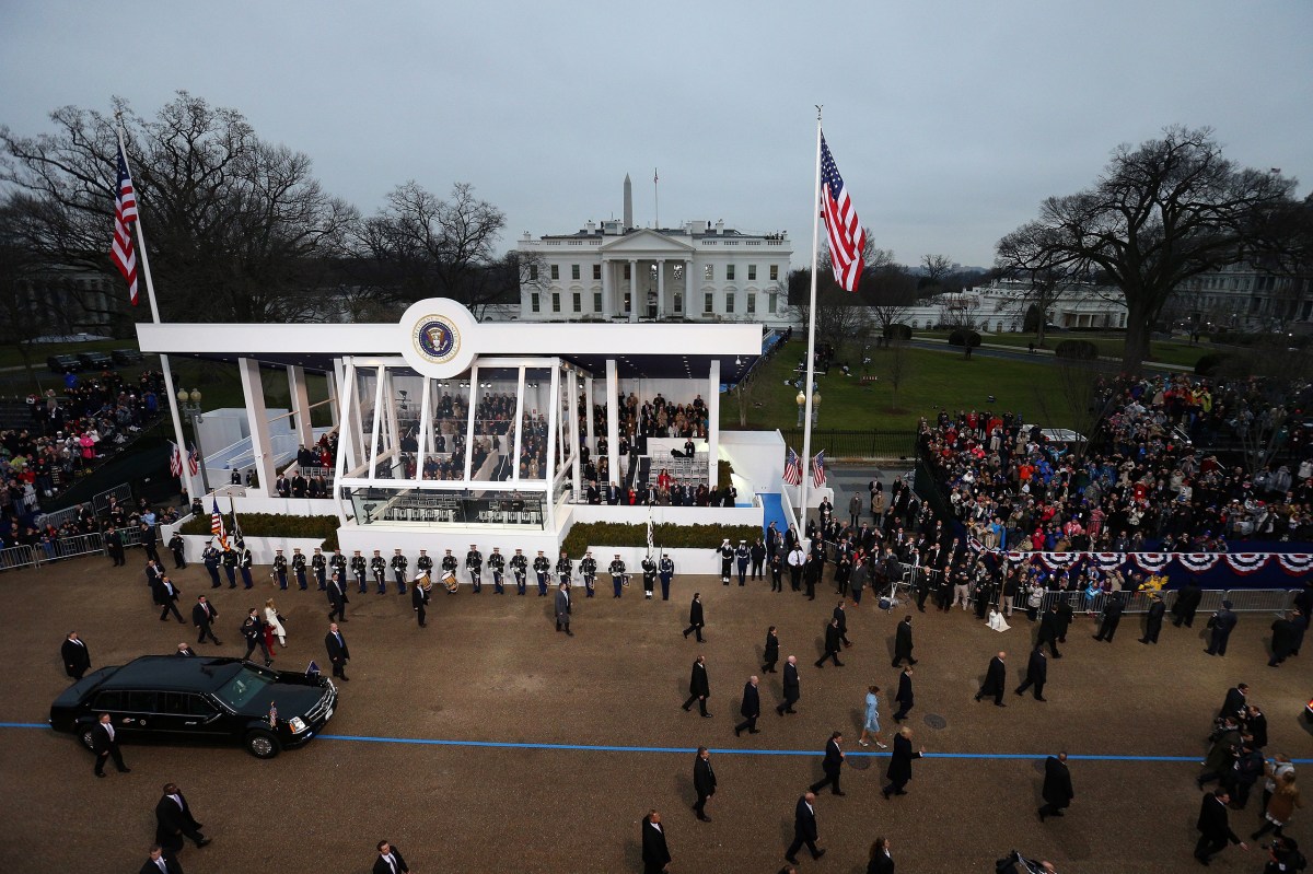 President Donald Trump waves to supporters as he walks along parade route with First Lady Melania Trump and son Barron in front of the White House on Jan. 20, 2017.