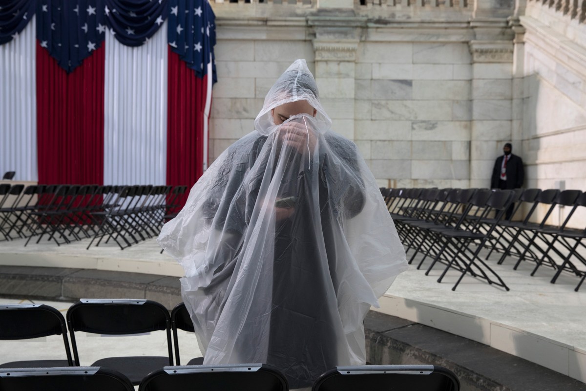 A man checks his phone in the rain on Capitol grounds in Washington, D.C., on Jan. 20, 2017.