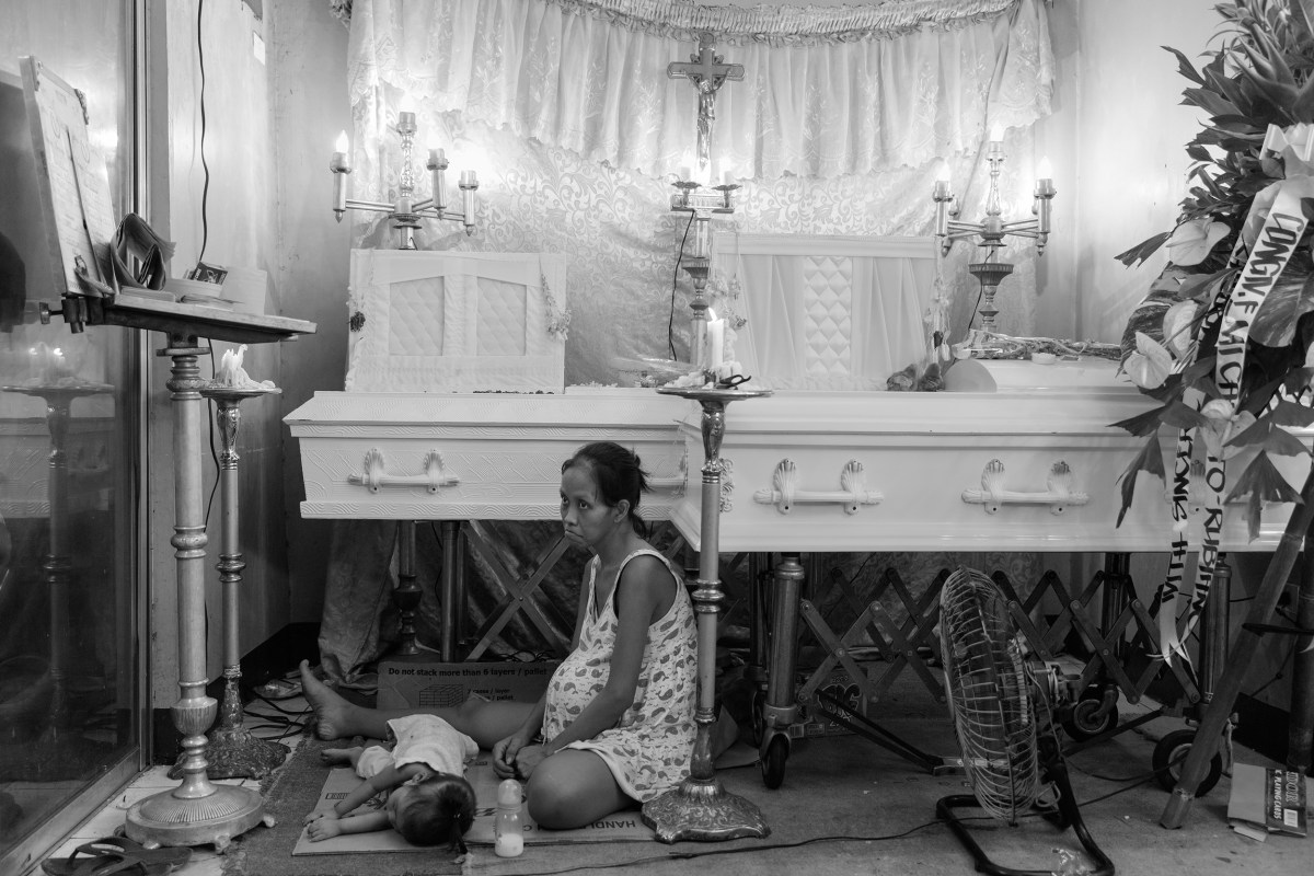 The coffins of Domingo MaÃÂ±osca and son Francis, 5, on Dec. 14. Both were killed by shots fired through the plywood window of their tiny Manila home. Elisabeth Navarro, nine months pregnant, survived with Erika, 1, and a second girl