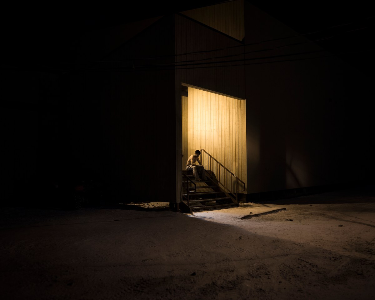 A man cooling down after playing soccer in the gym, Clyde River. The sports center is a refuge for many of the residents in Clyde River. Here they have the possibility to gather, have fun and participate in activities that can release the stress from everyday life.