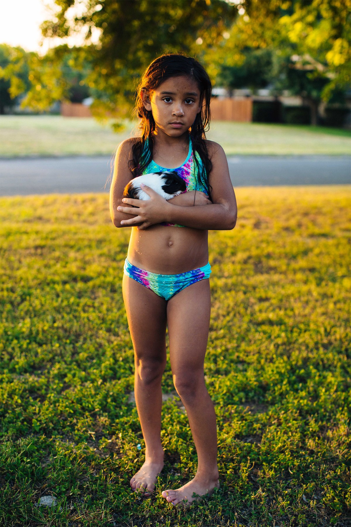 Layla poses for a portrait in the front yard with her guinea pig, Penelope. Sara Naomi Lewkowicz for TIME