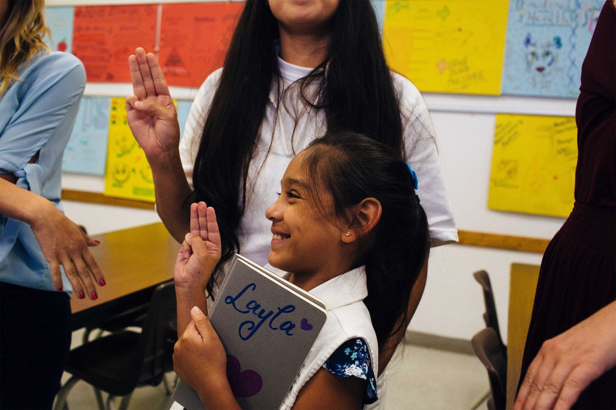 Layla, her mother Magan, and the other leaders and participants in Troop 1500 take the Girl Scouts pledge at the end of their prison visit. Sara Naomi Lewkowicz for TIME