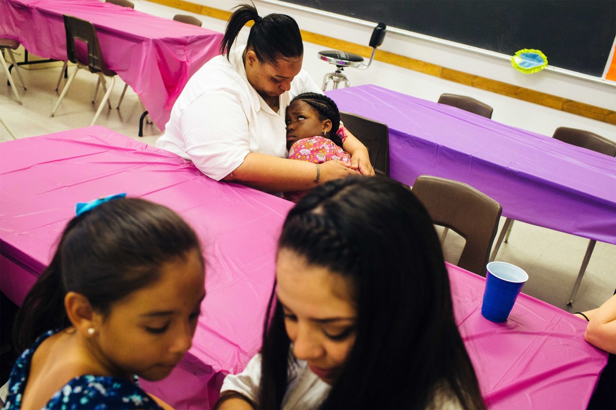 Trunarah Miller, 8, cuddles with her mother, Lakeshia Kennedy as Layla Arenas, 7, shares secrets with her mother Magan Garcia. Sara Naomi Lewkowicz for TIME
