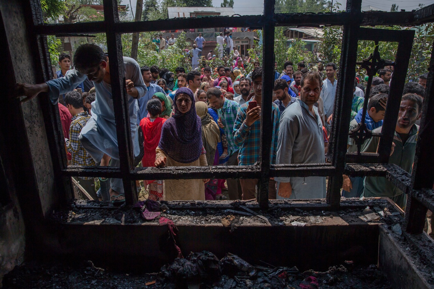 Villagers inspect a house damaged during a gun battle between Indian soldiers and suspected militants in Hakripora, about 22 miles (35 km.) south of Srinagar on Aug. 1, 2017. Large anti-India protests and clashes spearheaded mostly by students erupted in disputed Kashmir on Tuesday after government forces killed two senior militants in a gunbattle and fatally shot a protester during an ensuing demonstration demanding an end to Indian rule.