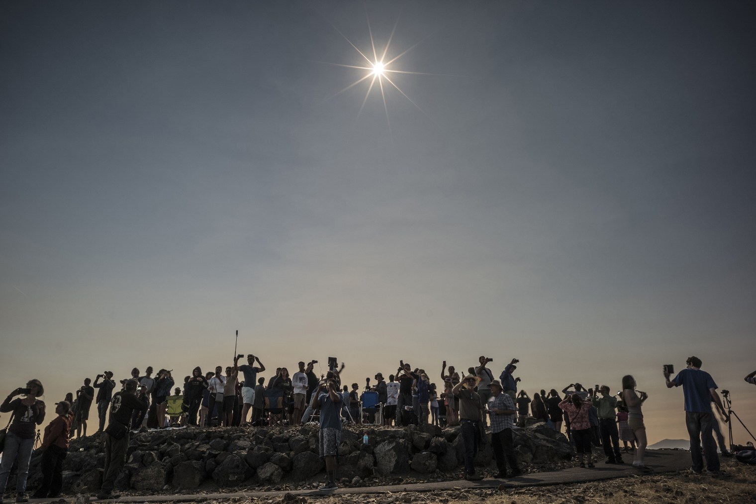 People wait to watch the eclipse in Madras, Ore., on Aug. 21, 2017.