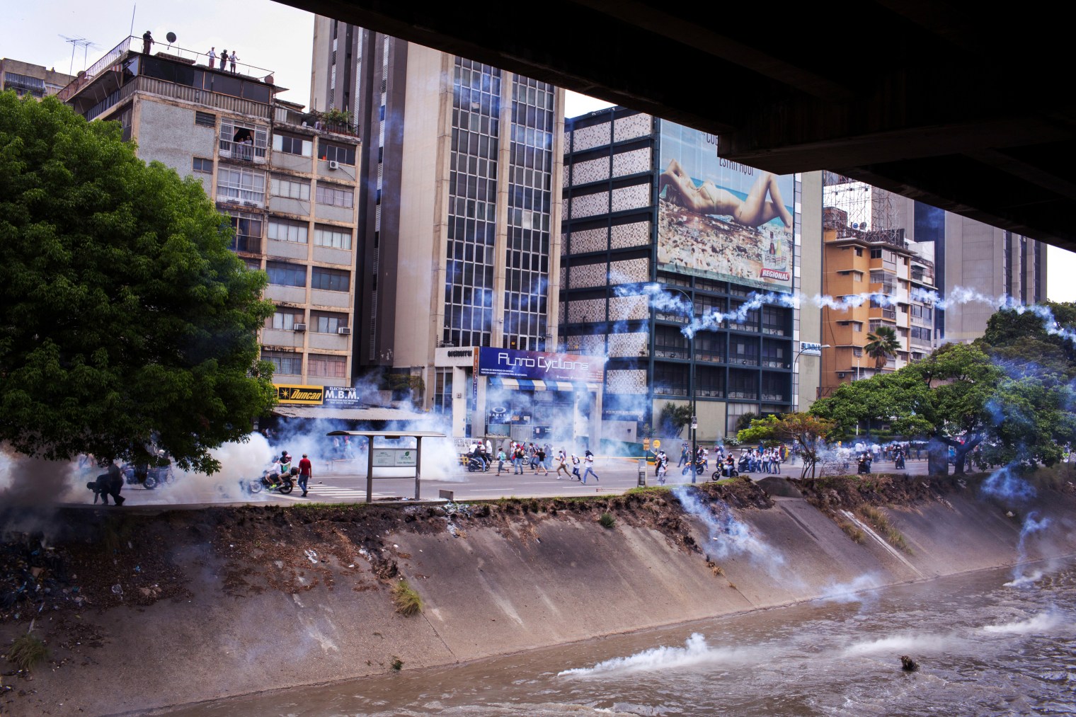 Protesters retreat from heavy tear gas in Caracas on April 19, 2017.