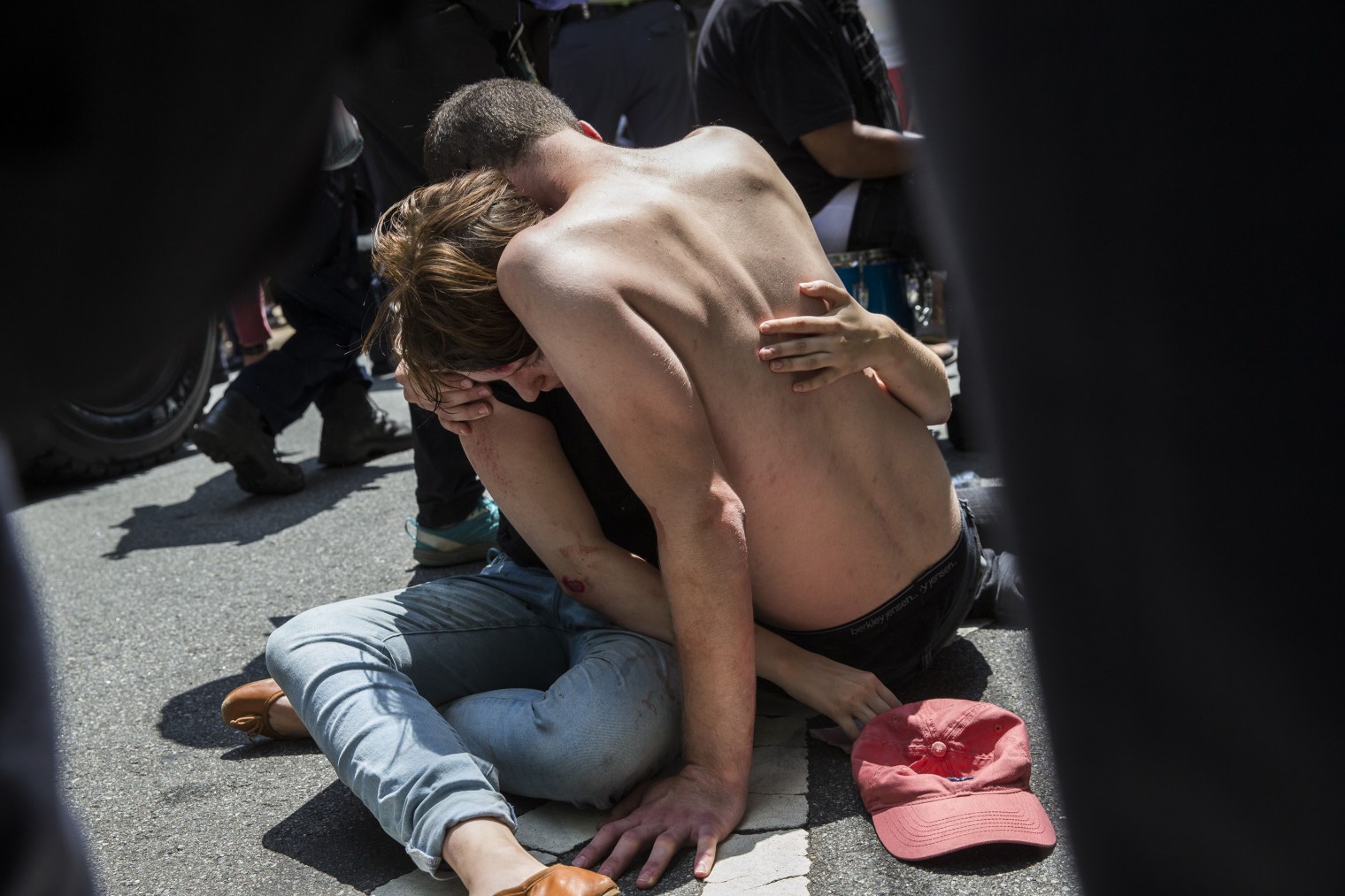 A man embraces an injured woman after a car rammed into a crowd of anti-white nationalist protesters in Charlottesville, Va., on Aug.12, 2017.
