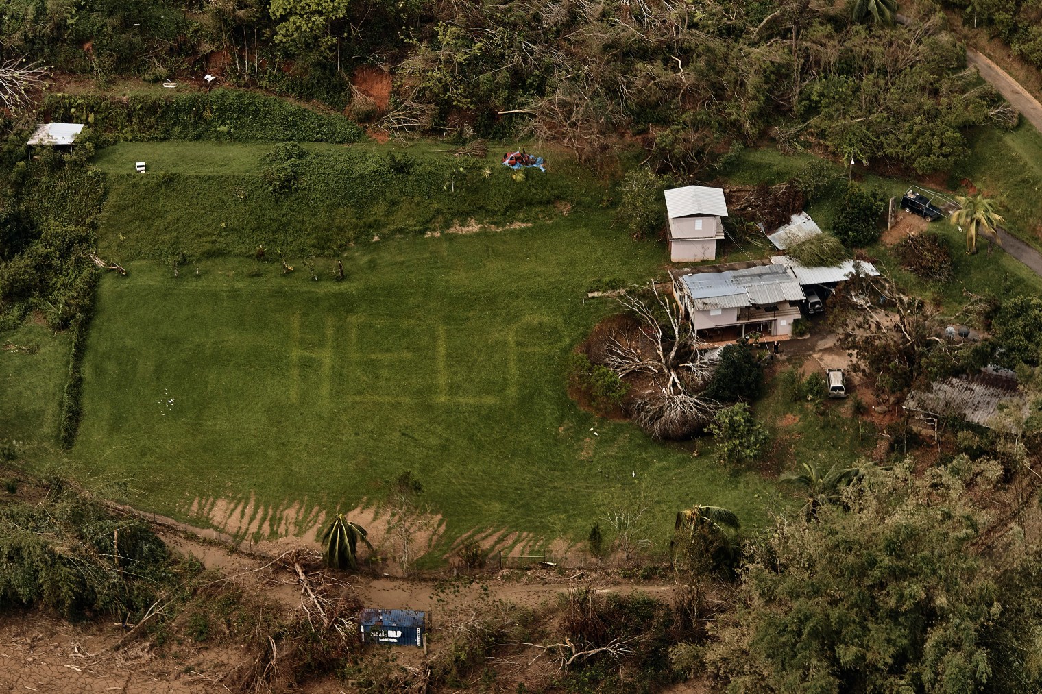 The desperate message âHELPâ is seen on the lawn of a home near Utuado, Puerto Rico, in early October. Photographer @andreskudacki, who was covering the aftermath of Hurricane Maria for TIME, came across this scene during a helicopter flyover in the central mountainous region, where rescuers had previously searched for those in need. Police who originally saw the sign landed to find people without food or water, isolated as a nearby river swelled.